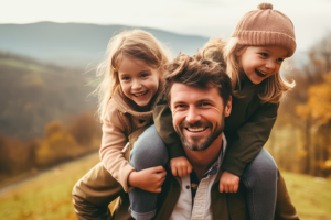 Photo - Happy dad with two daughters outside